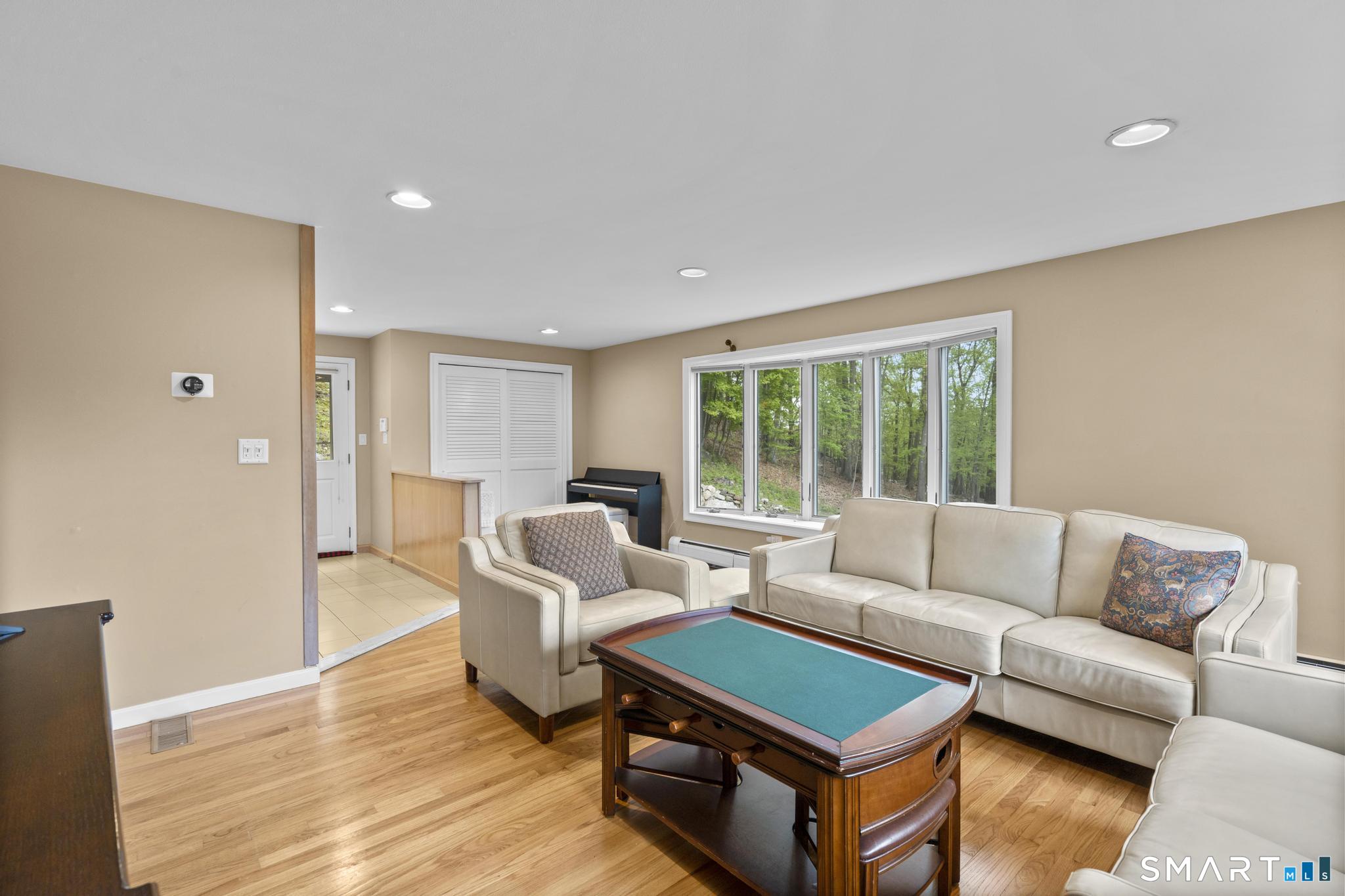 832 Quarter Mile Road Orange, CT 06477 - Photo 25 of 39 a living room with furniture and a large window