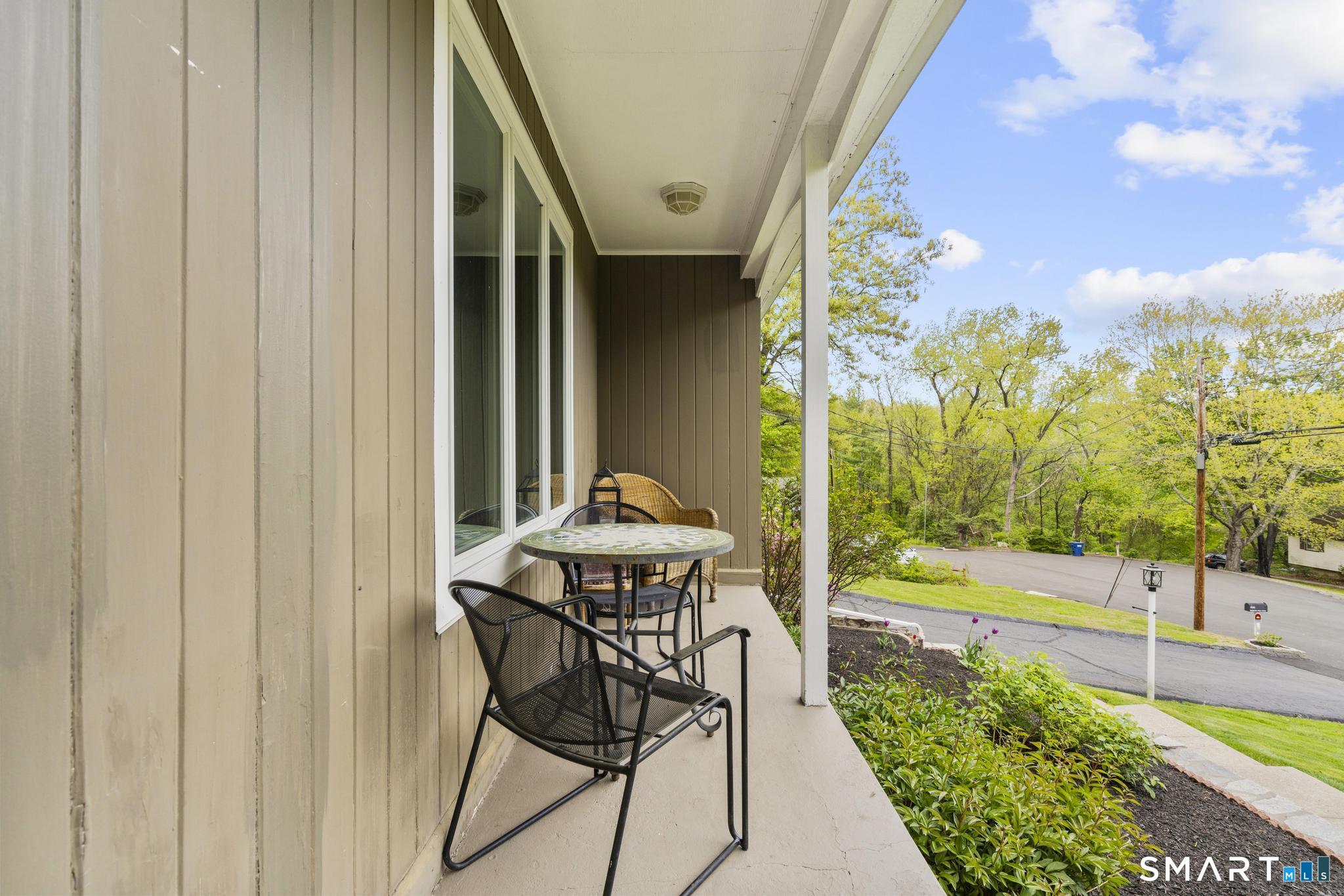 832 Quarter Mile Road Orange, CT 06477 - Photo 3 of 39 a view of a patio with table and chairs and potted plants