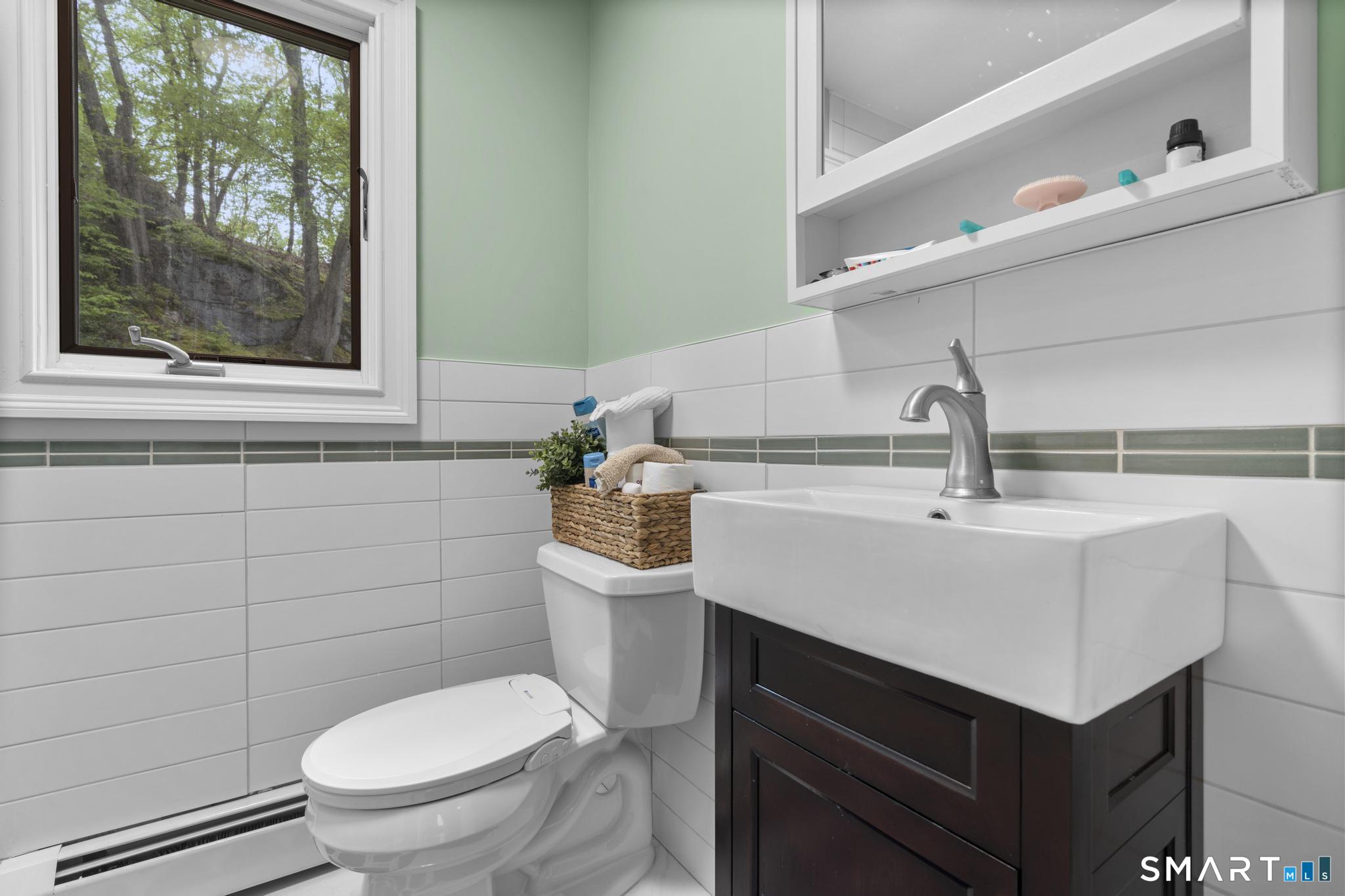 832 Quarter Mile Road Orange, CT 06477 - Photo 31 of 39 a bathroom with a sink toilet and window