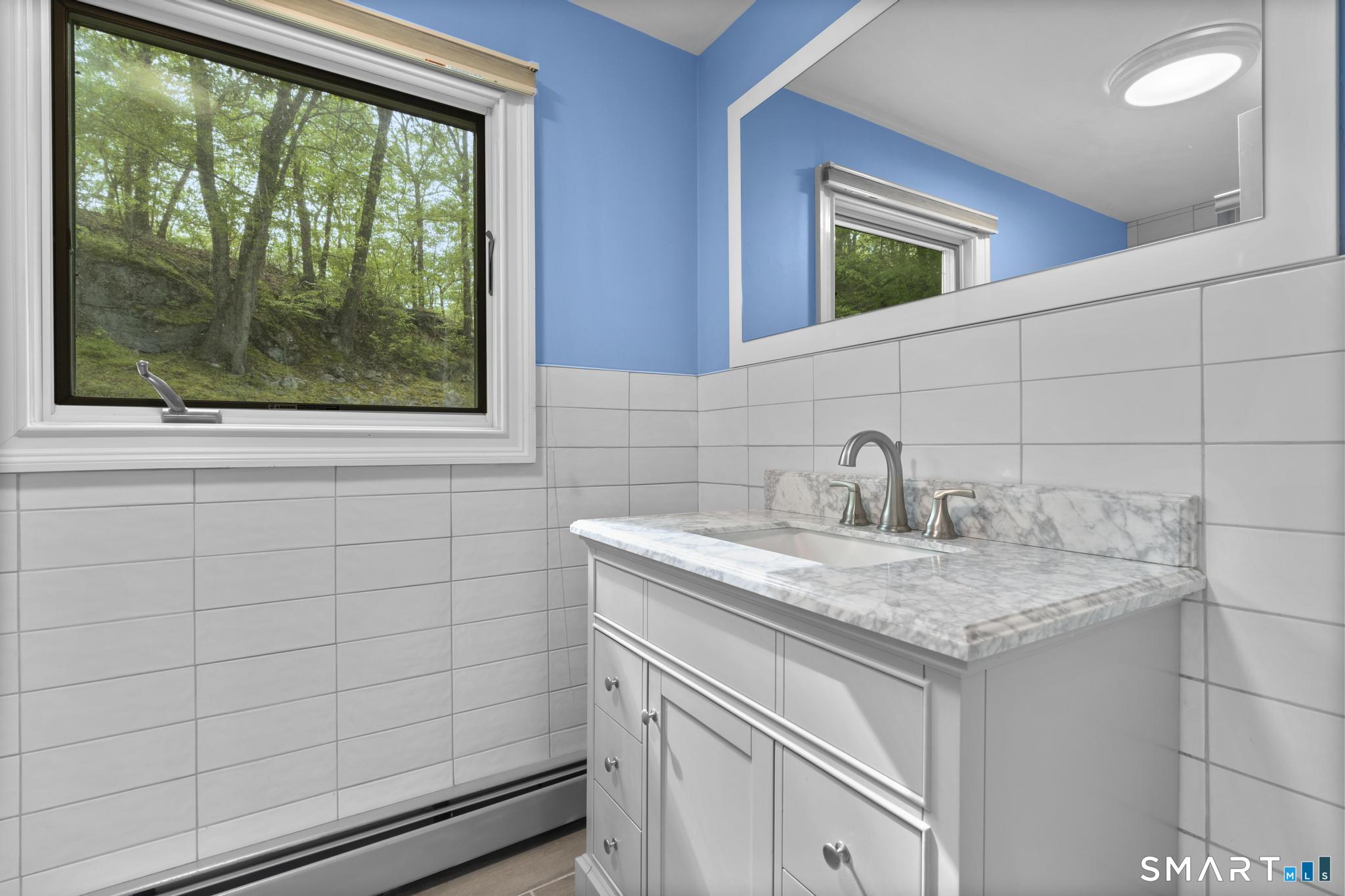 832 Quarter Mile Road Orange, CT 06477 - Photo 32 of 39 a bathroom with a sink and a vanity