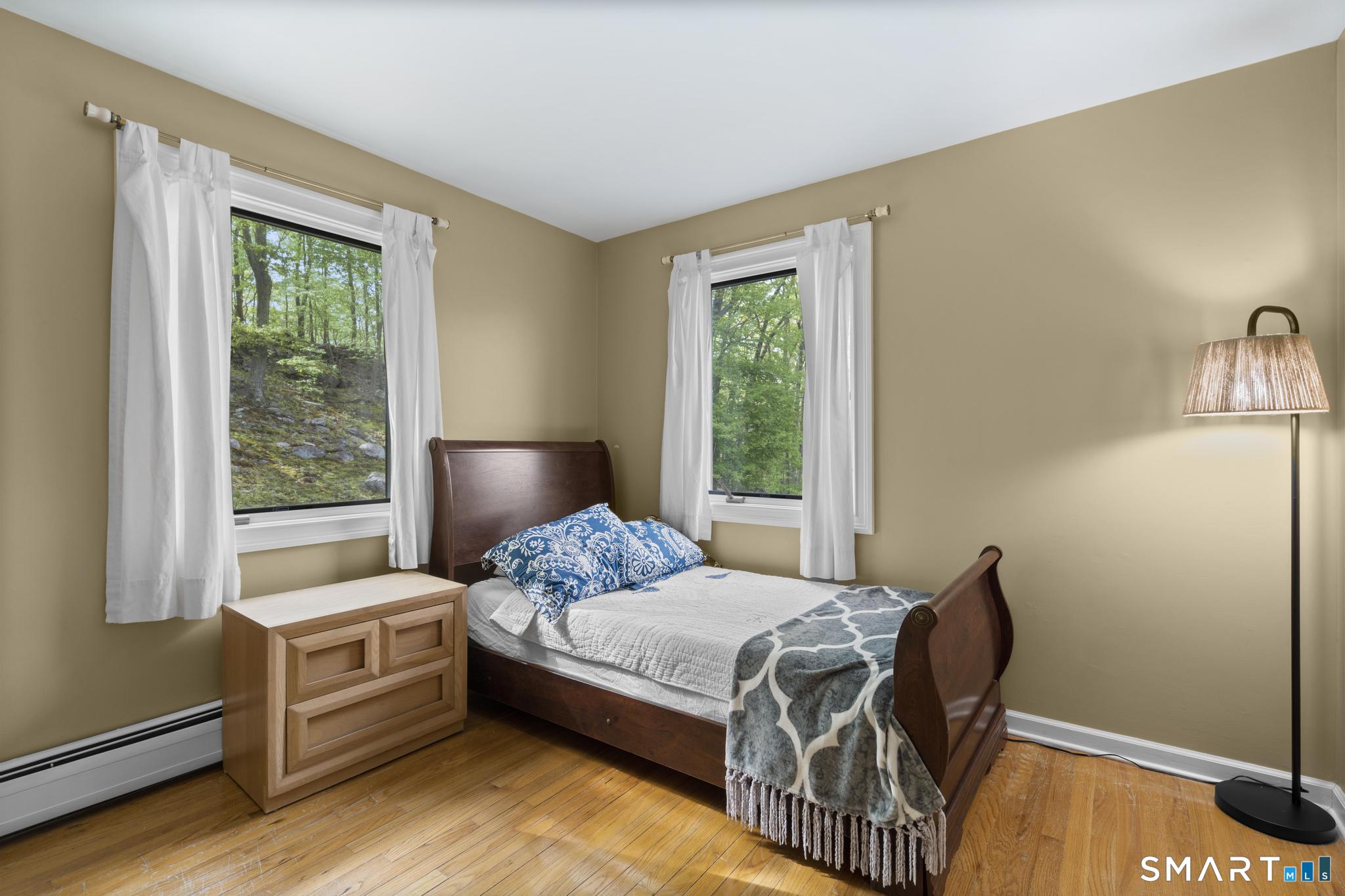 832 Quarter Mile Road Orange, CT 06477 - Photo 34 of 39 a bedroom with a bed and a window