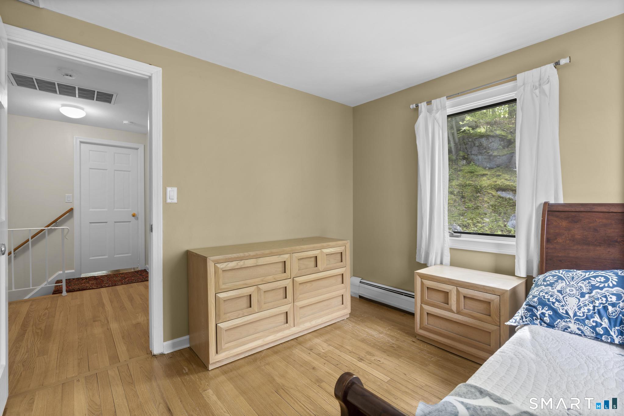 832 Quarter Mile Road Orange, CT 06477 - Photo 35 of 39 a bedroom with furniture and a window