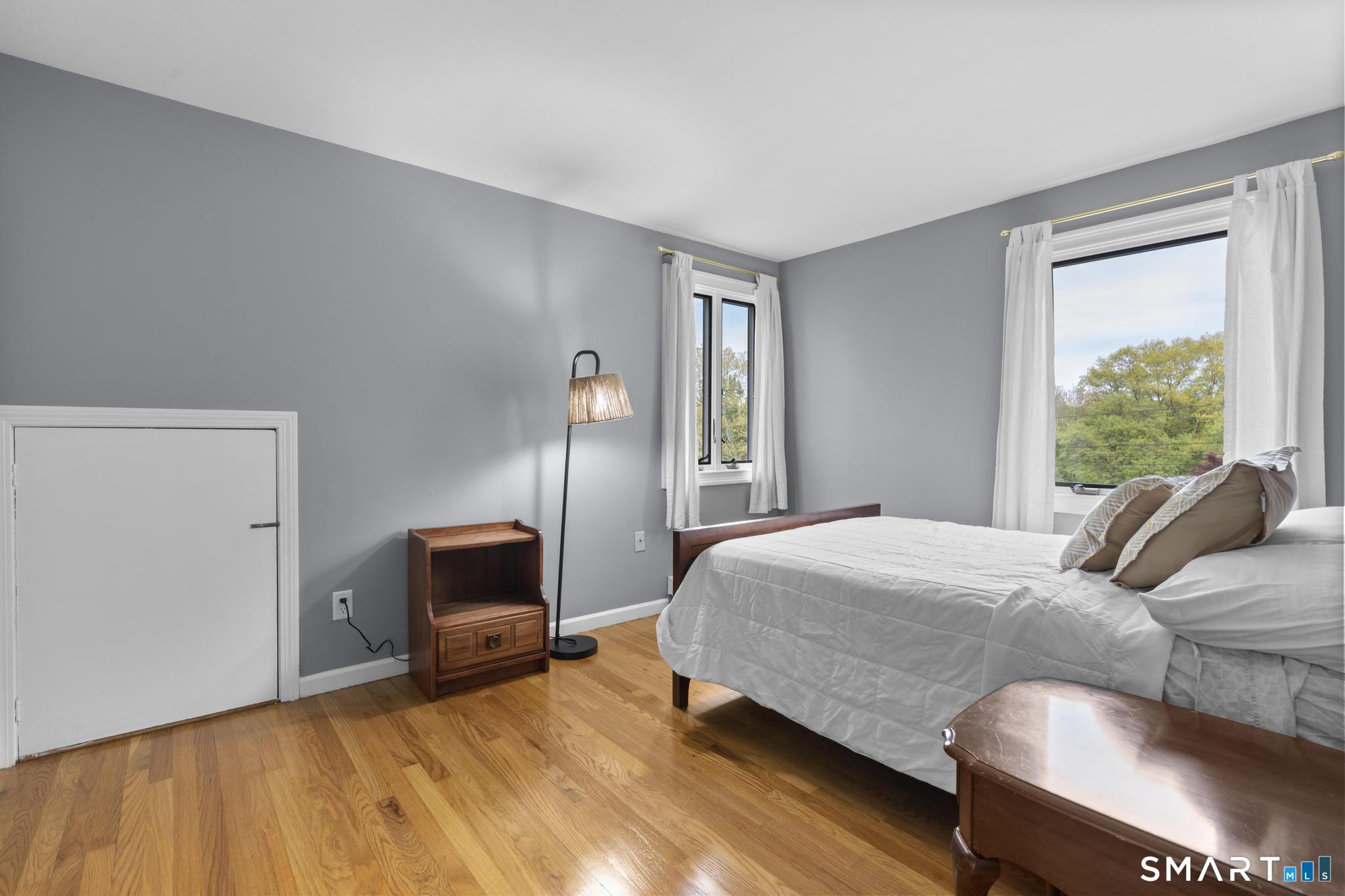 832 Quarter Mile Road Orange, CT 06477 - Photo 36 of 39 a bedroom with a bed and a chair