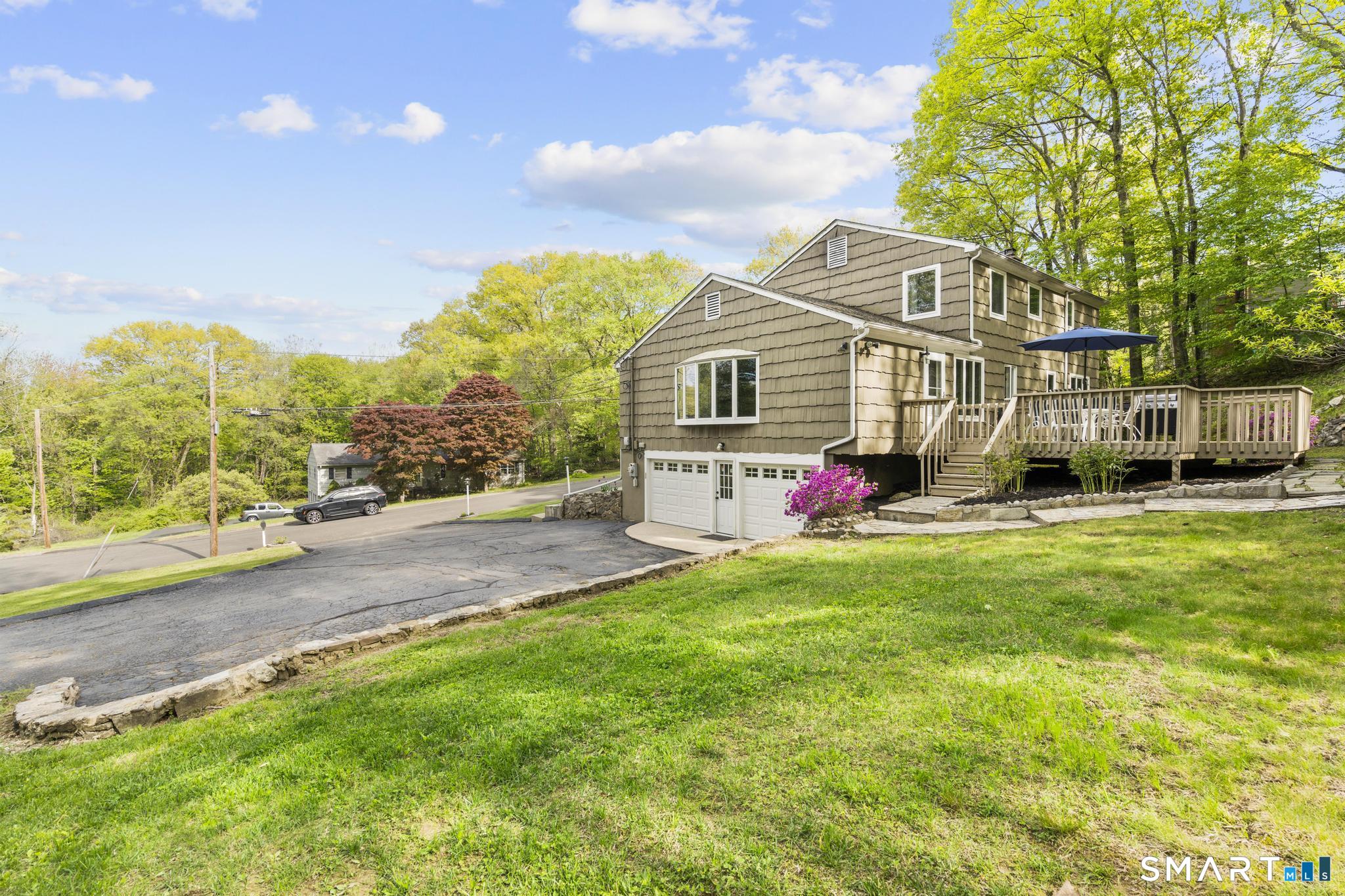 832 Quarter Mile Road Orange, CT 06477 - Photo 4 of 39 a front view of house with yard and green space
