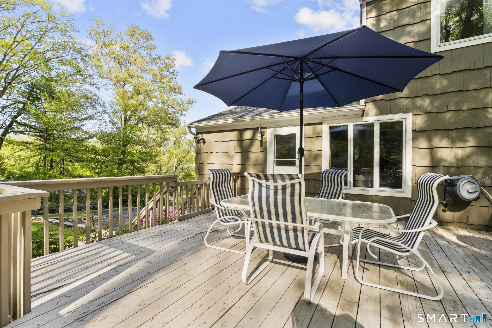 832 Quarter Mile Road Orange, CT 06477 - Photo 6 of 39 a view of a chair and tables in the balcony