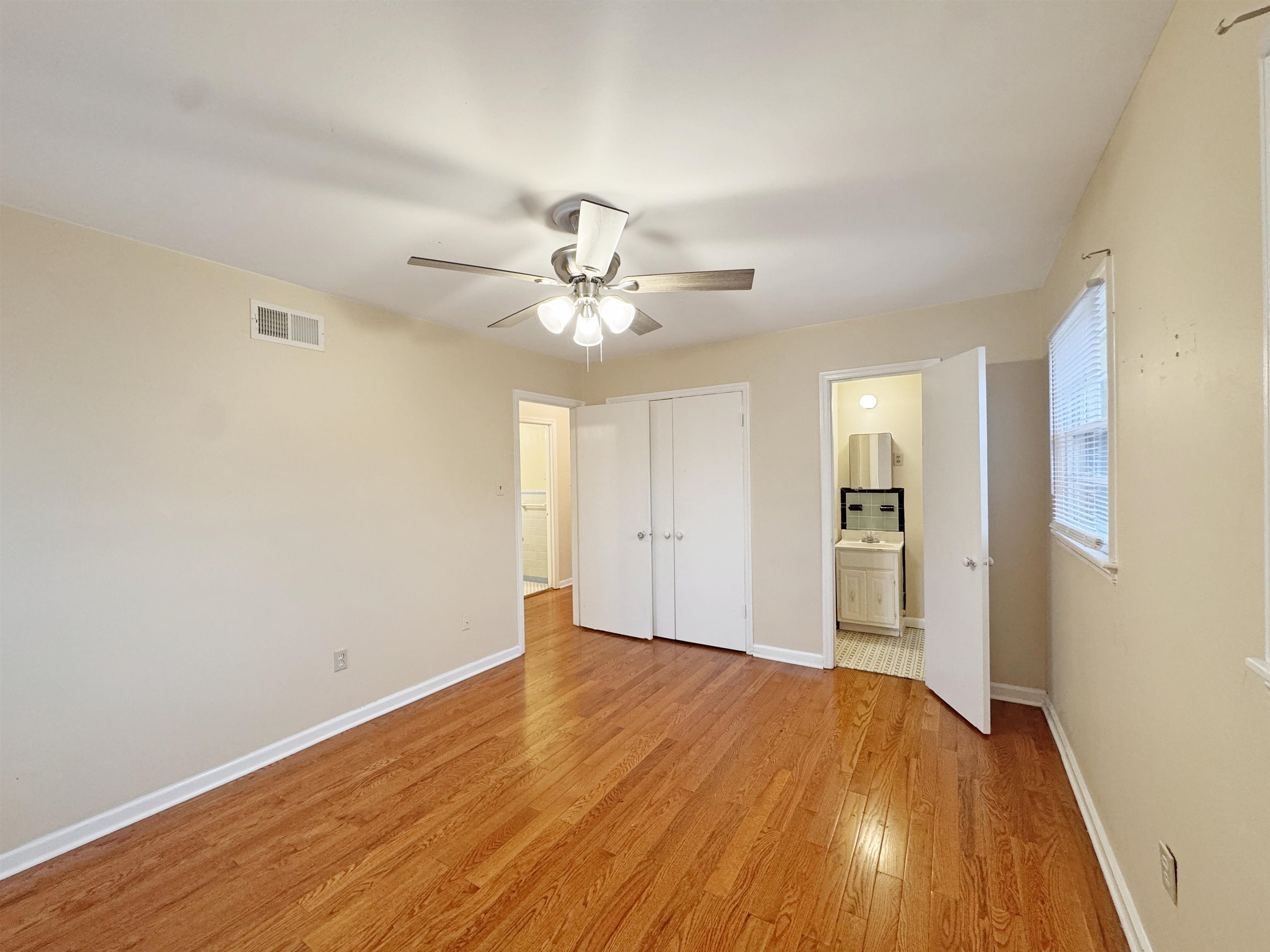 1519 South White Station Road Memphis, TN 38117 - Photo 12 of 31 a view of a room with wooden floor and ceiling fan