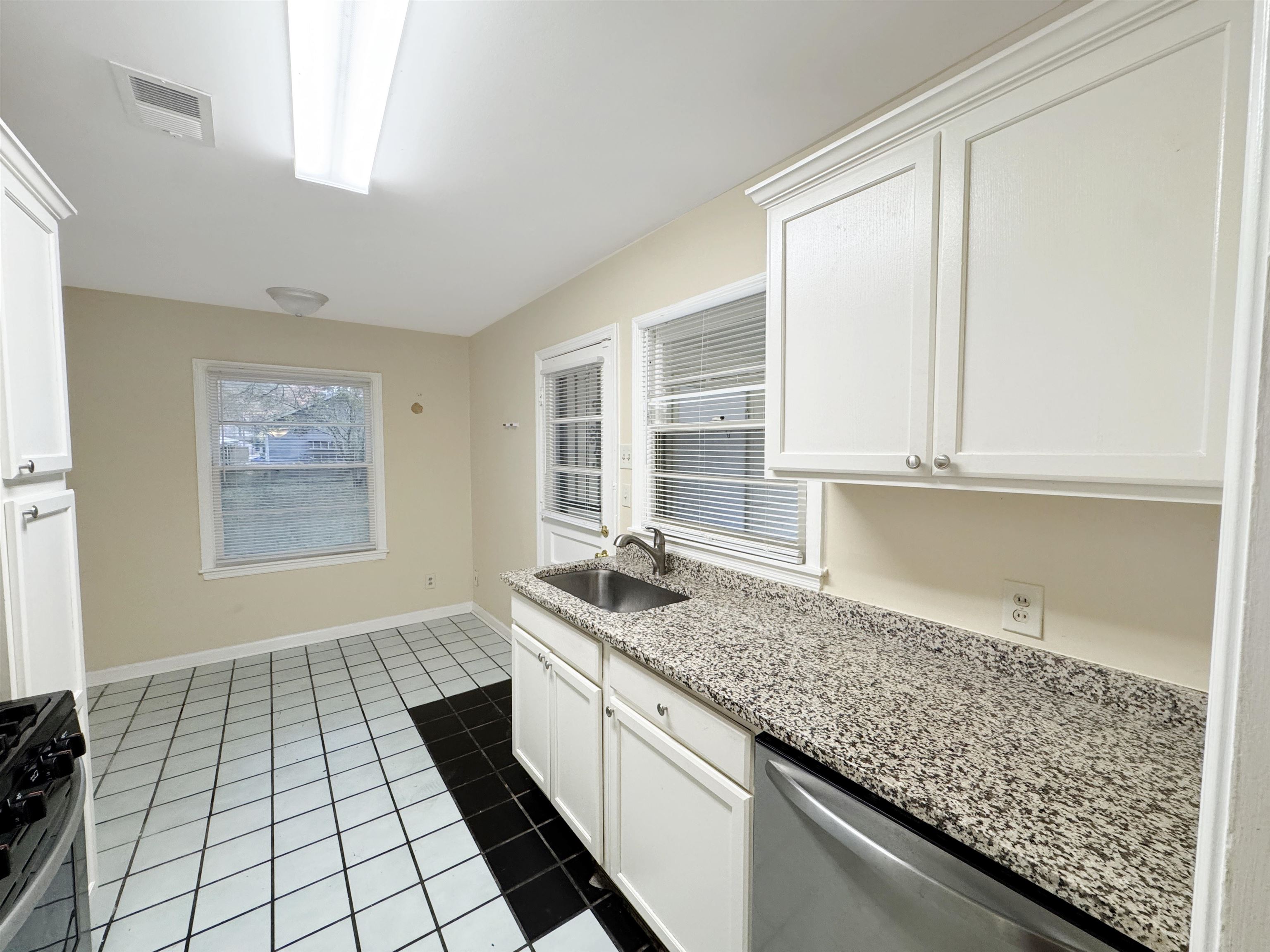1519 South White Station Road Memphis, TN 38117 - Photo 20 of 31 a kitchen with granite countertop a sink and a white cabinets