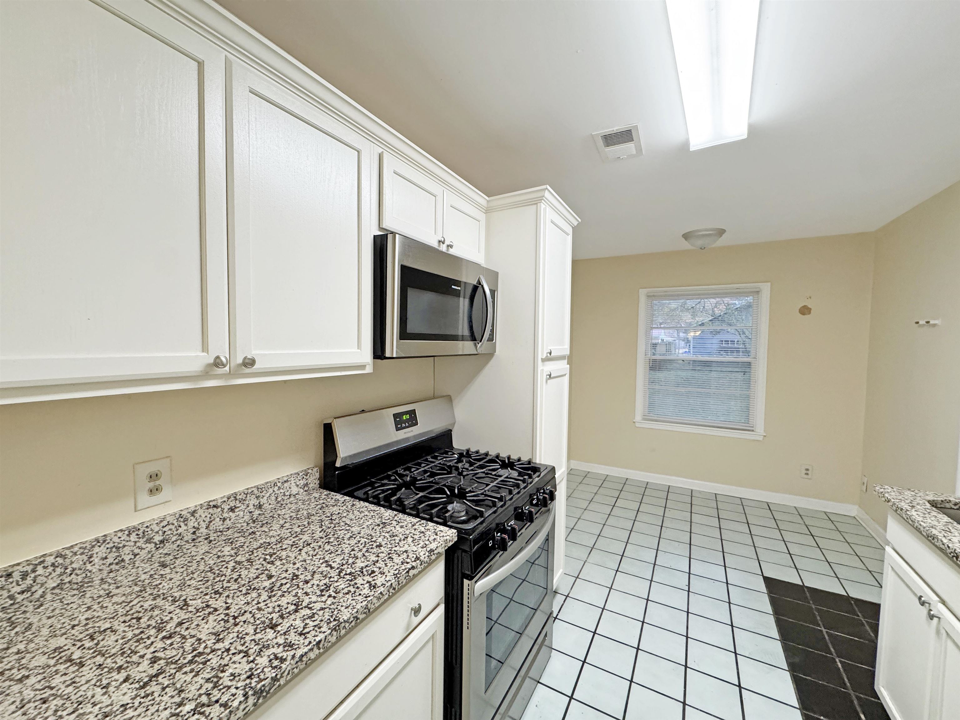 1519 South White Station Road Memphis, TN 38117 - Photo 21 of 31 a kitchen with stainless steel appliances granite countertop a stove a sink and a microwave