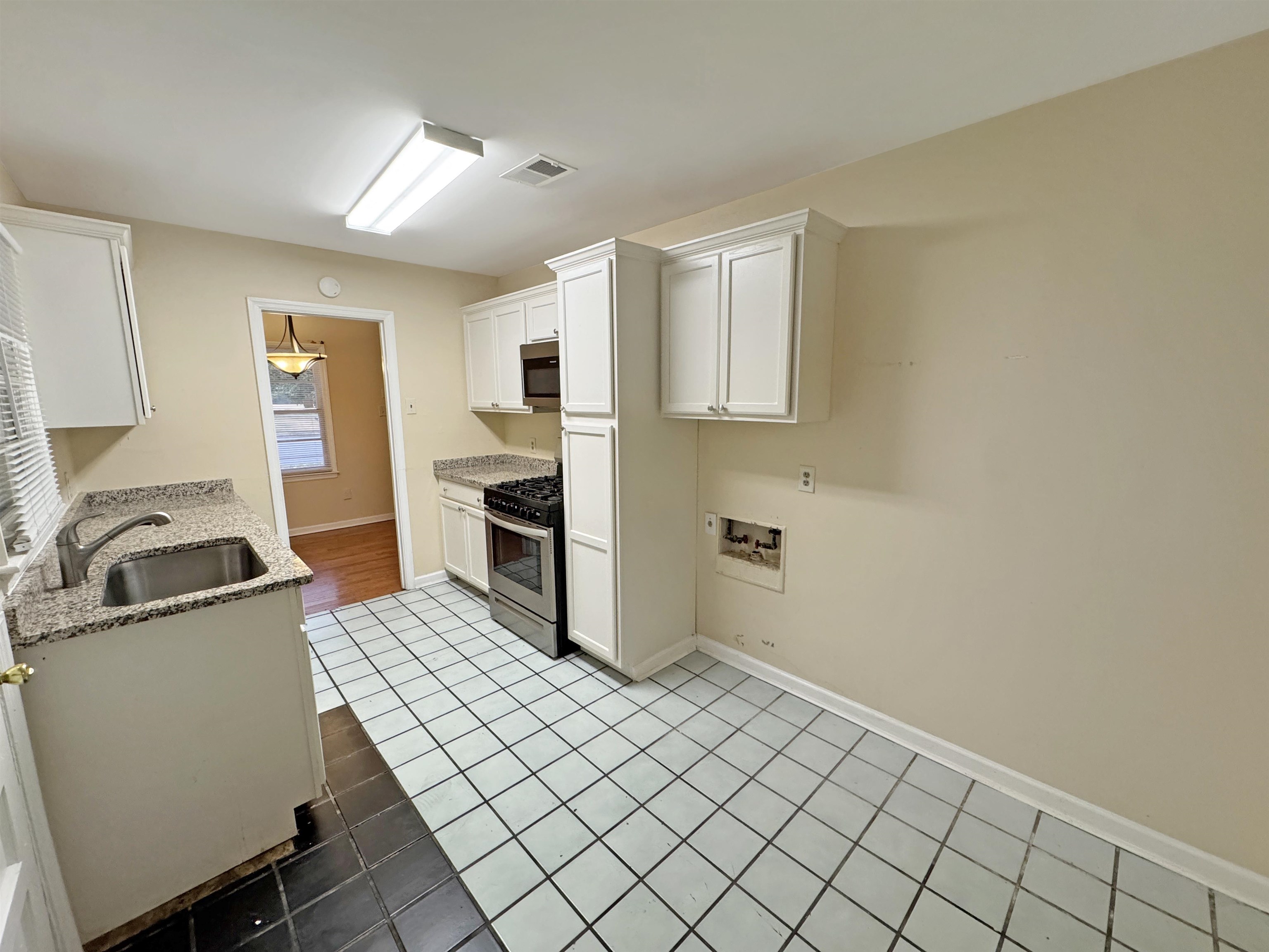 1519 South White Station Road Memphis, TN 38117 - Photo 23 of 31 a kitchen with a sink a stove and cabinets