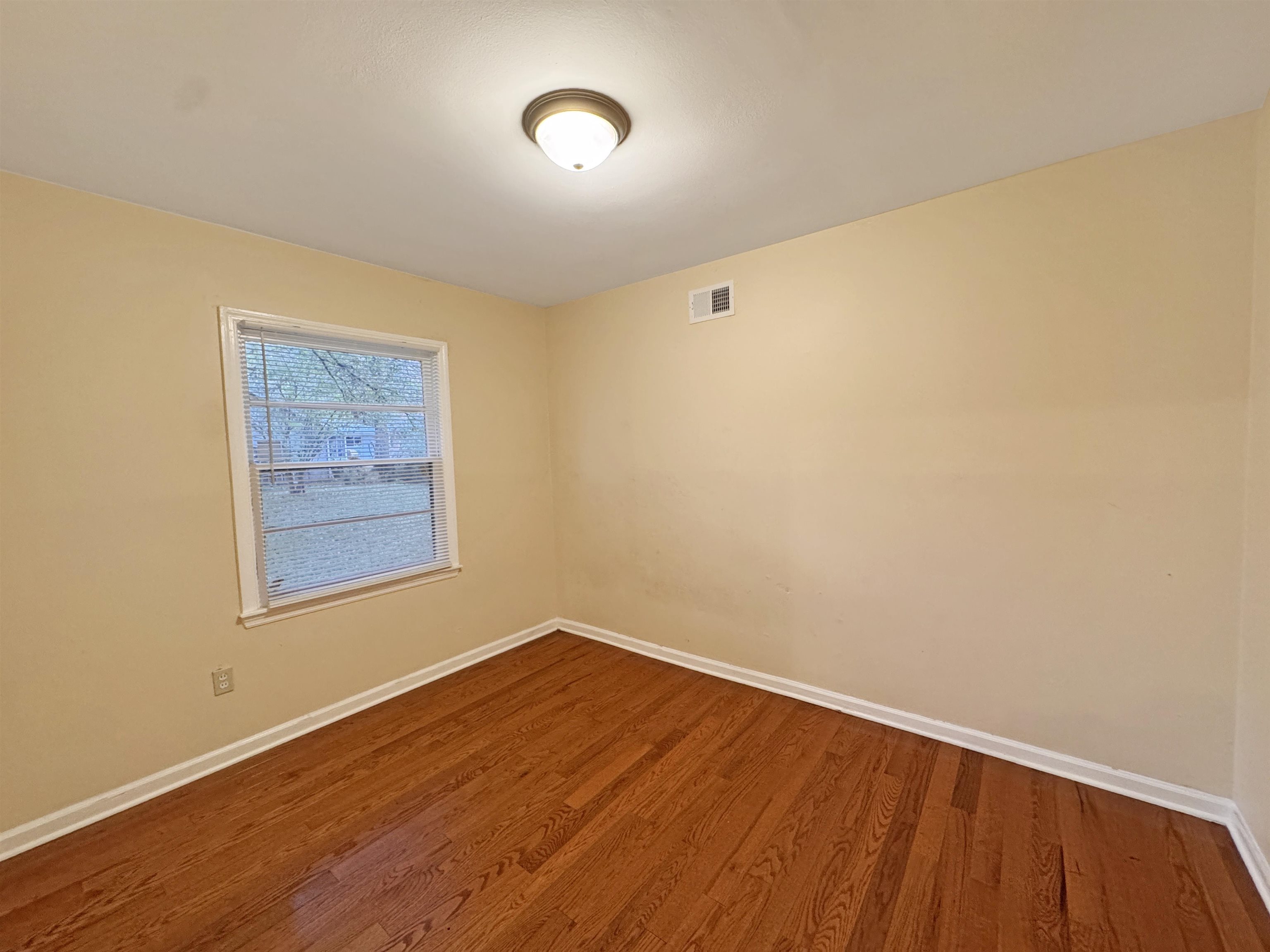 1519 South White Station Road Memphis, TN 38117 - Photo 26 of 31 a view of an empty room with wooden floor and a window