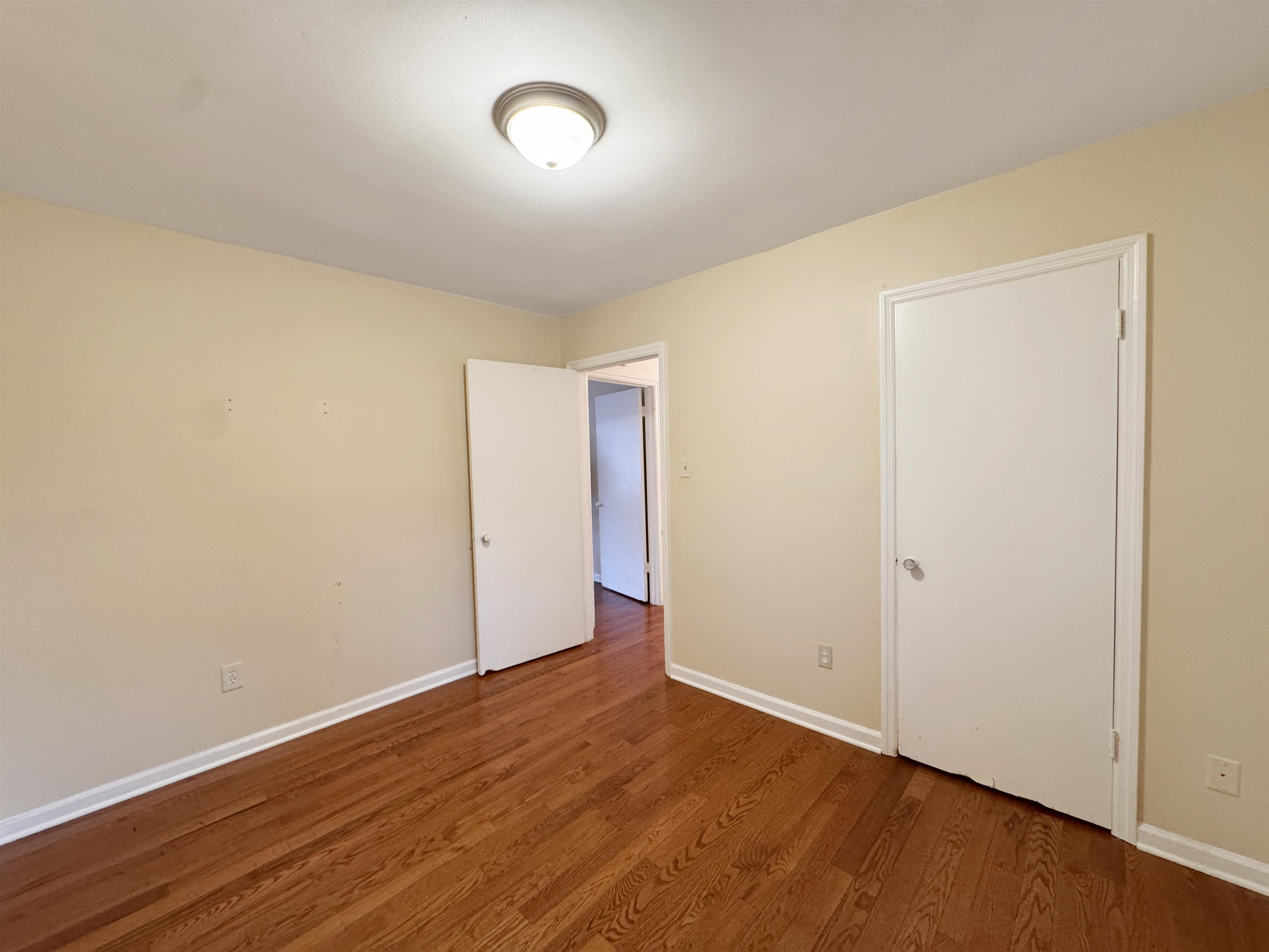 1519 South White Station Road Memphis, TN 38117 - Photo 27 of 31 an empty room with wooden floor and windows