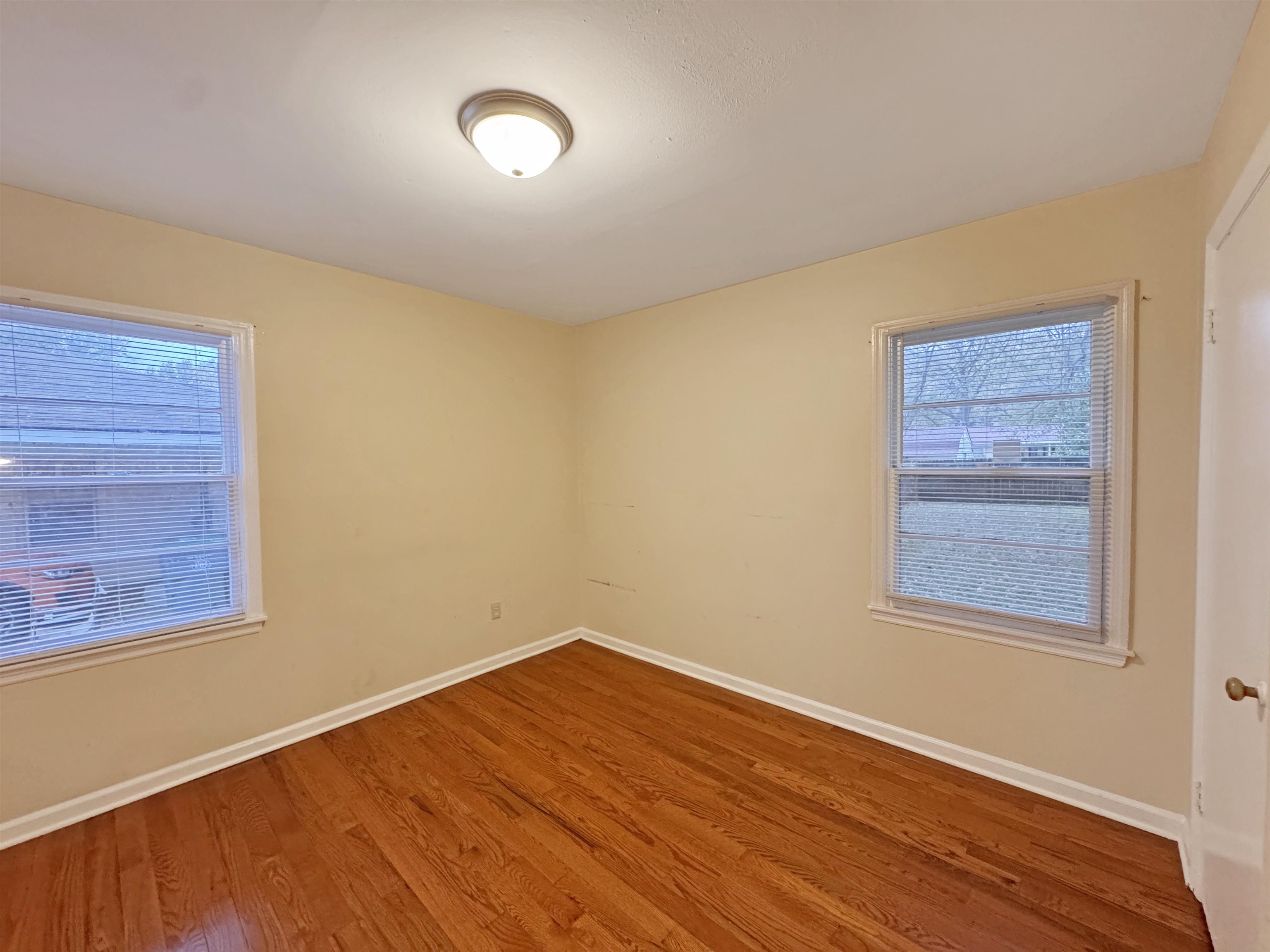 1519 South White Station Road Memphis, TN 38117 - Photo 28 of 31 a view of an empty room with wooden floor and a window