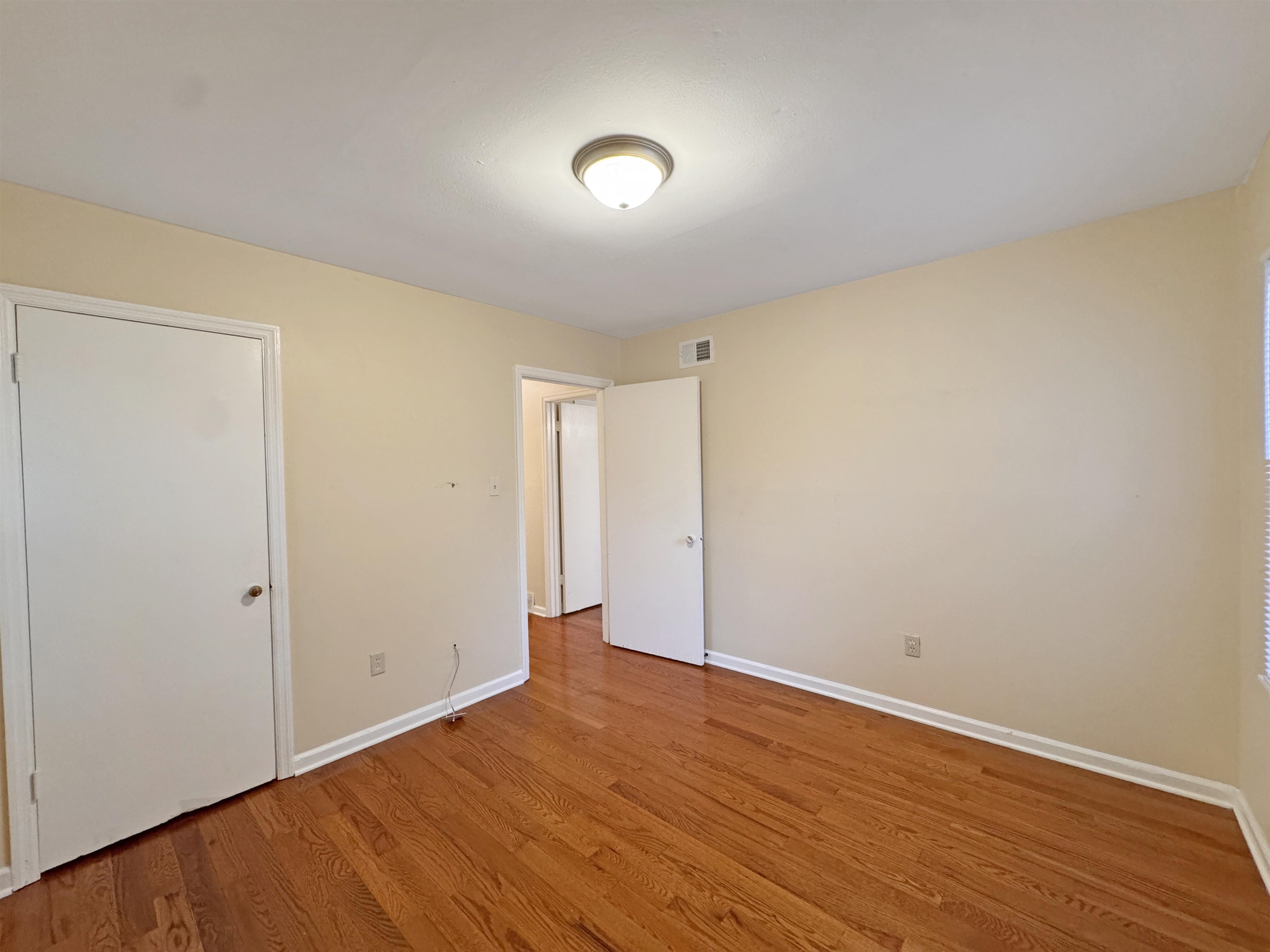 1519 South White Station Road Memphis, TN 38117 - Photo 29 of 31 a view of an empty room with wooden floor and a window
