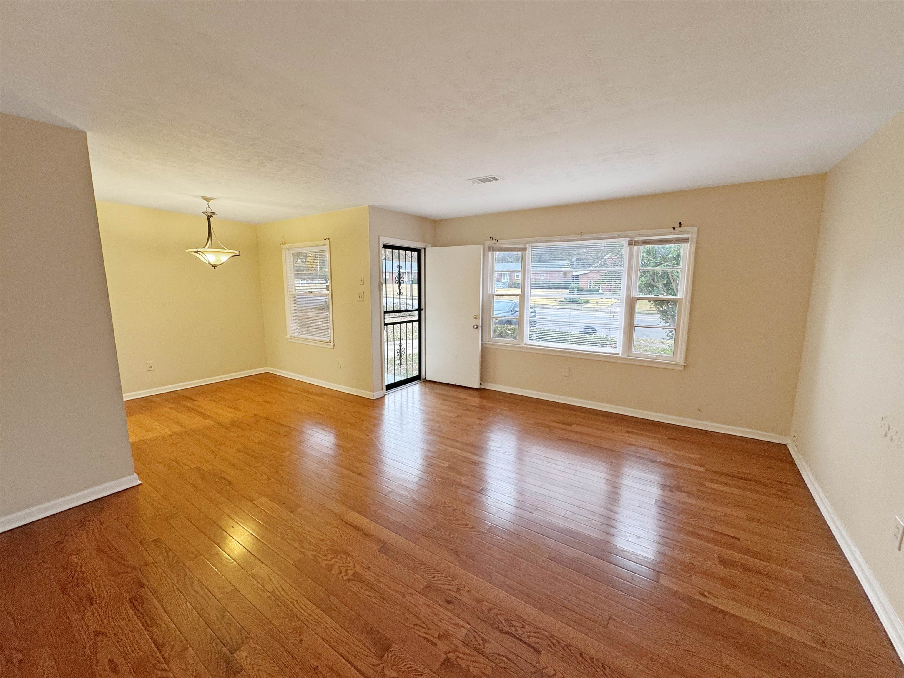 1519 South White Station Road Memphis, TN 38117 - Photo 4 of 31 an empty room with wooden floor and windows