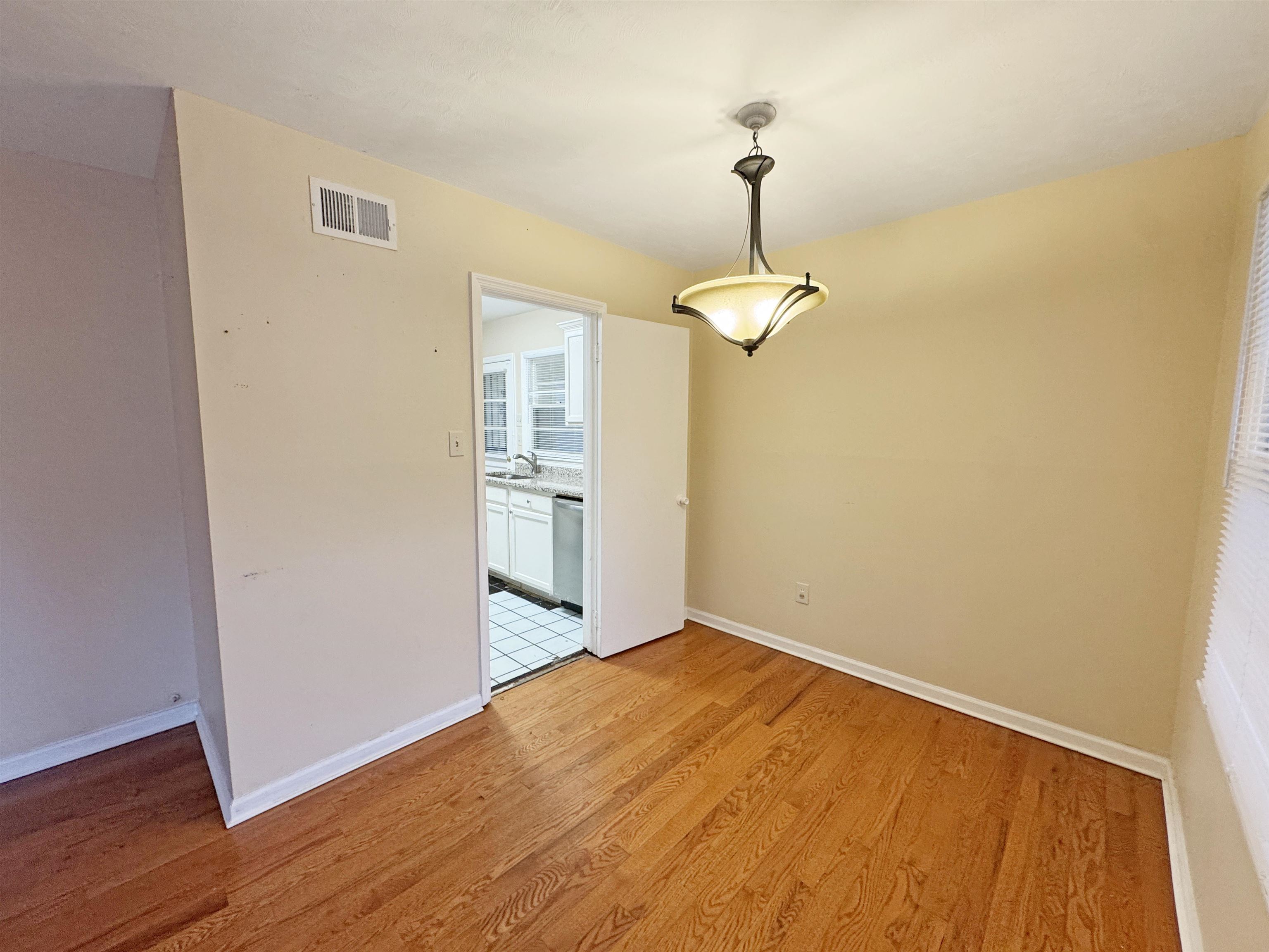 1519 South White Station Road Memphis, TN 38117 - Photo 5 of 31 a view of a room with wooden floor and chandelier