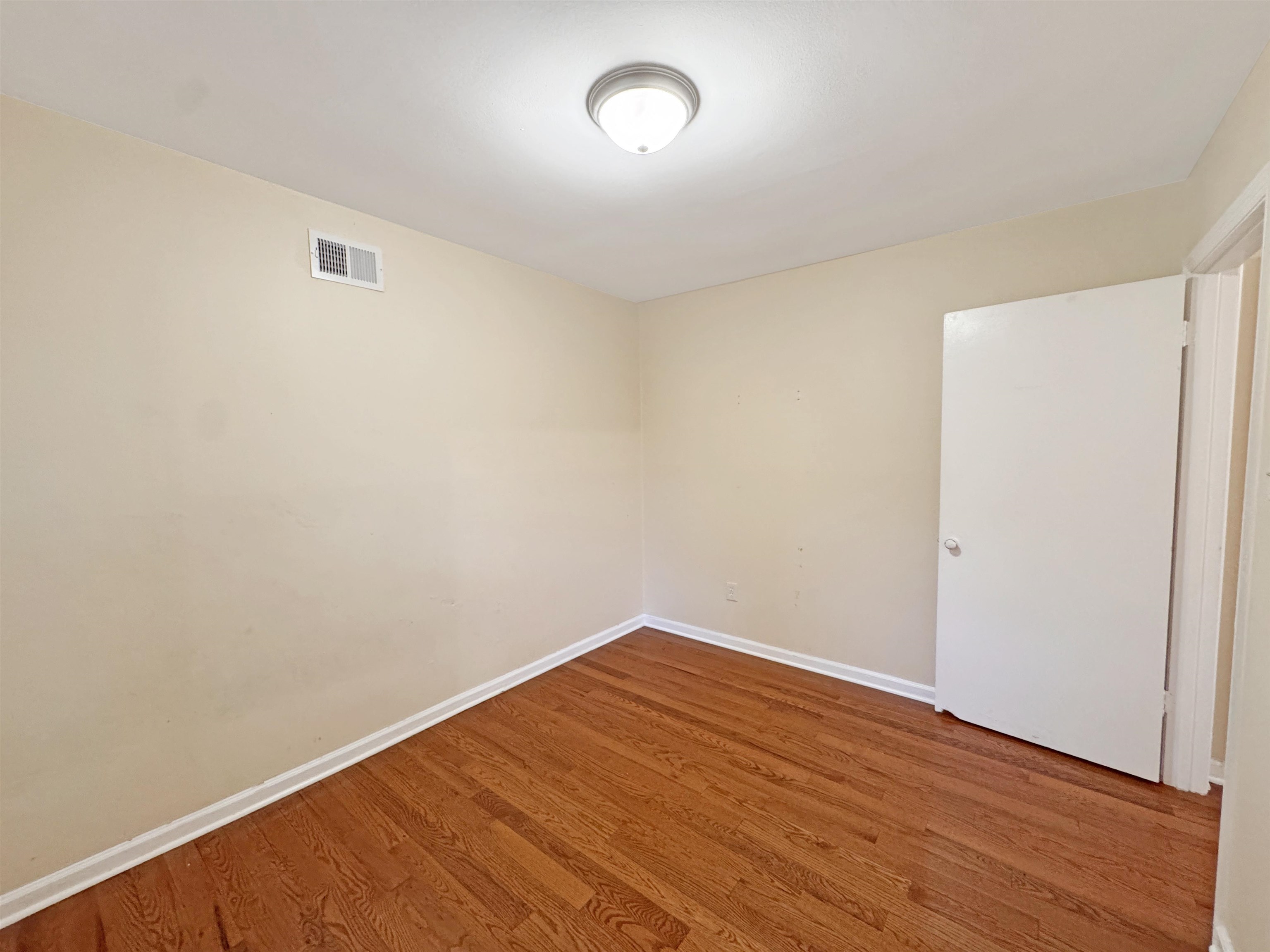 1519 South White Station Road Memphis, TN 38117 - Photo 7 of 31 a view of room with wooden floor