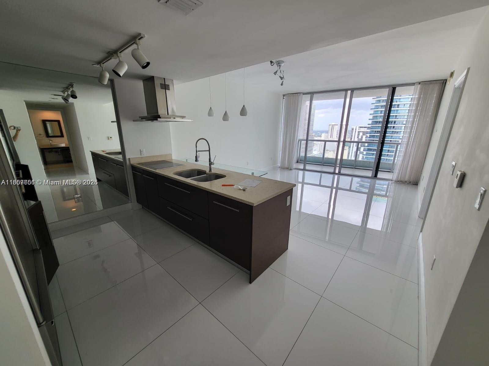 485 Brickell Avenue, Unit 4103 Miami, FL 33131 - Photo 6 of 13 a kitchen with stainless steel appliances granite countertop a sink and a stove
