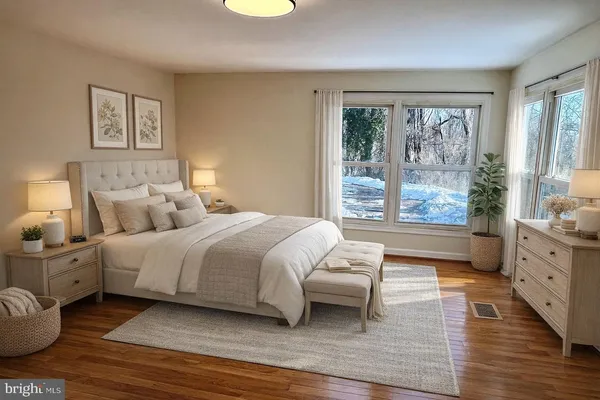 a spacious bedroom with a large bed and a window