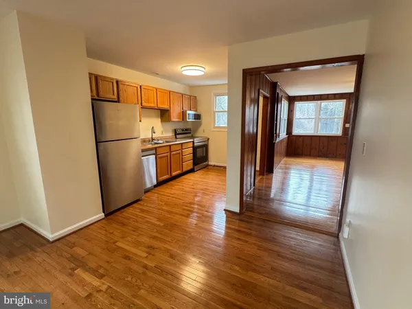 a view of a refrigerator in kitchen and wooden floor