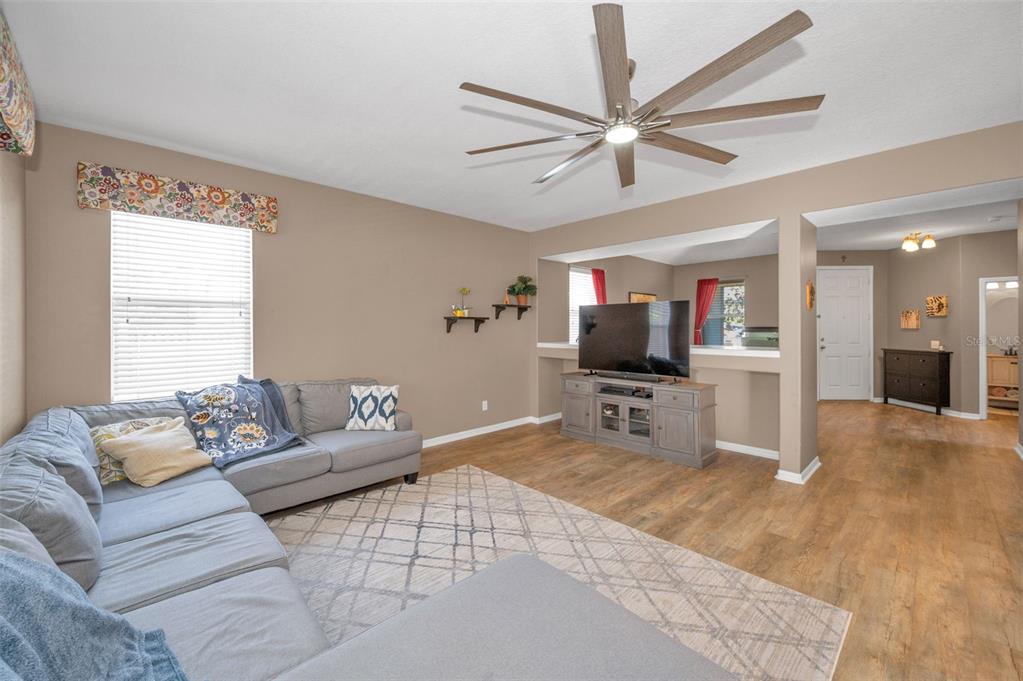 3619 Hatchbend Way Wesley Chapel, FL 33544 - Photo 11 of 86 a living room with furniture and a flat screen tv