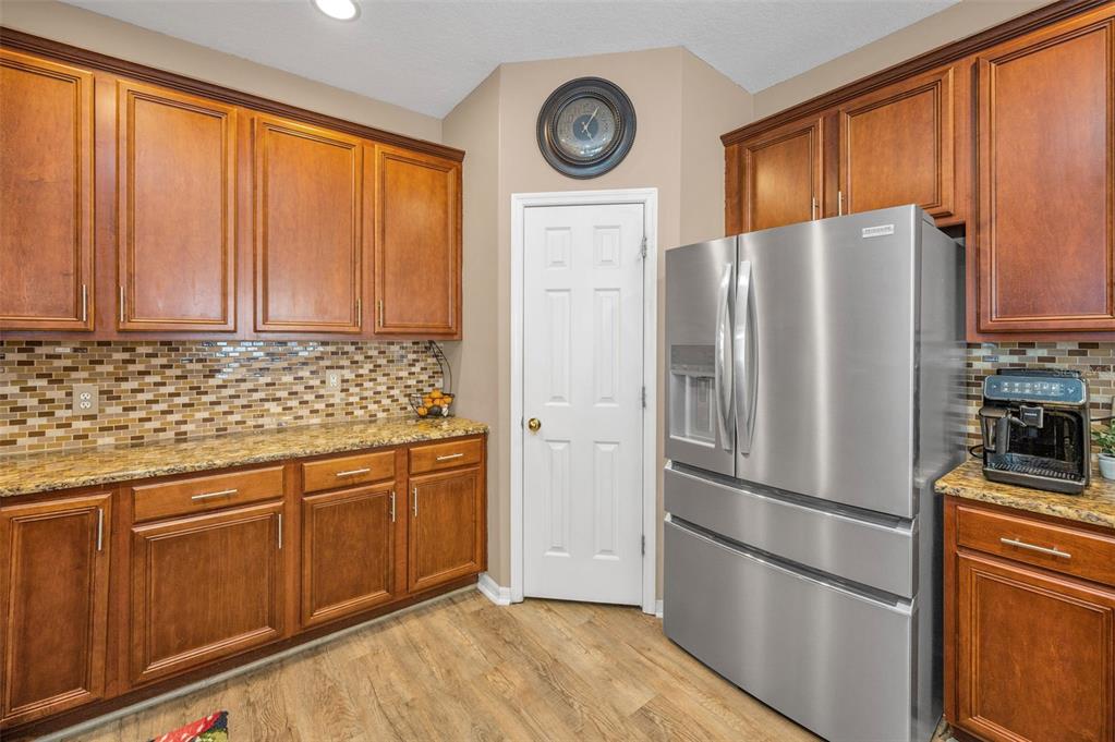 3619 Hatchbend Way Wesley Chapel, FL 33544 - Photo 17 of 86 a kitchen with stainless steel appliances granite countertop a refrigerator and a stove top oven