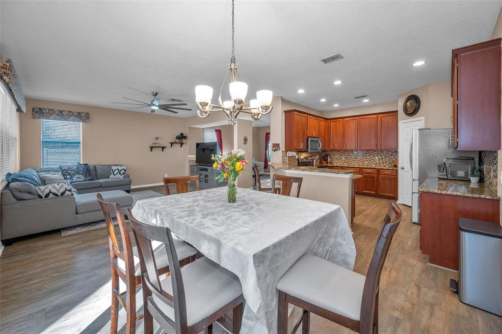 3619 Hatchbend Way Wesley Chapel, FL 33544 - Photo 21 of 86 a view of a dining room with furniture and wooden floor