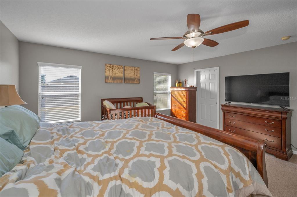 3619 Hatchbend Way Wesley Chapel, FL 33544 - Photo 27 of 86 a bedroom with a large bed and a flat screen tv