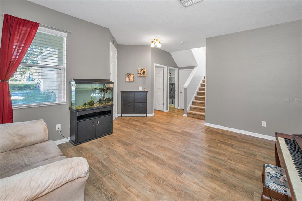3619 Hatchbend Way Wesley Chapel, FL 33544 - Photo 7 of 86 a living room with furniture and a flat screen tv