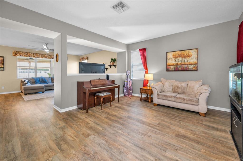 3619 Hatchbend Way Wesley Chapel, FL 33544 - Photo 9 of 86 a living room with furniture and a flat screen tv