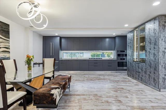 a kitchen with stainless steel appliances kitchen island granite countertop a refrigerator and a sink