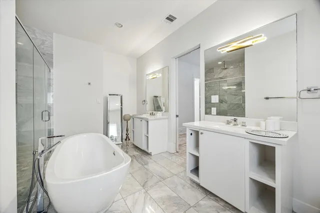 a spacious bathroom with a bathtub and shower