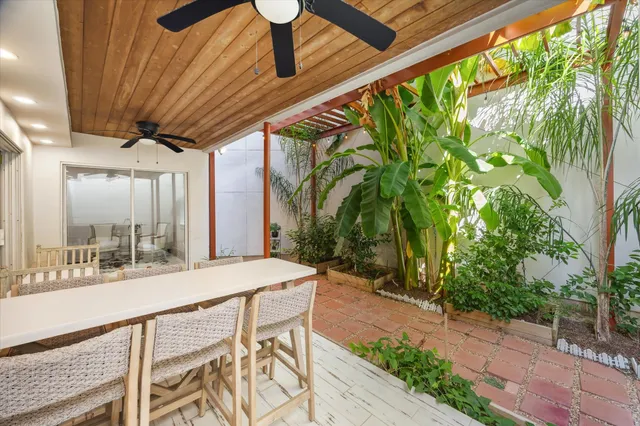 a patio with yard and outdoor seating