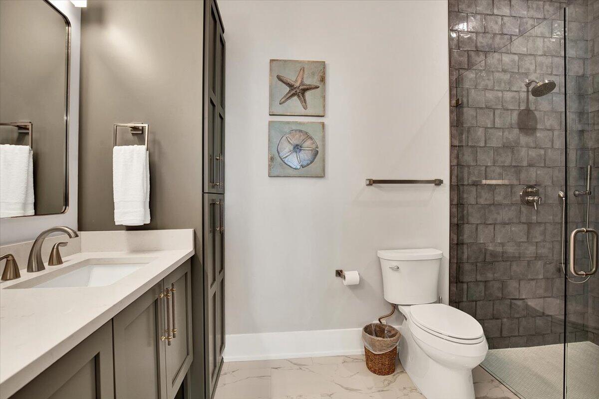 16418 Front Beach Road Panama City Beach, FL 32413 - Photo 17 of 40 a bathroom with a granite countertop toilet sink and mirror
