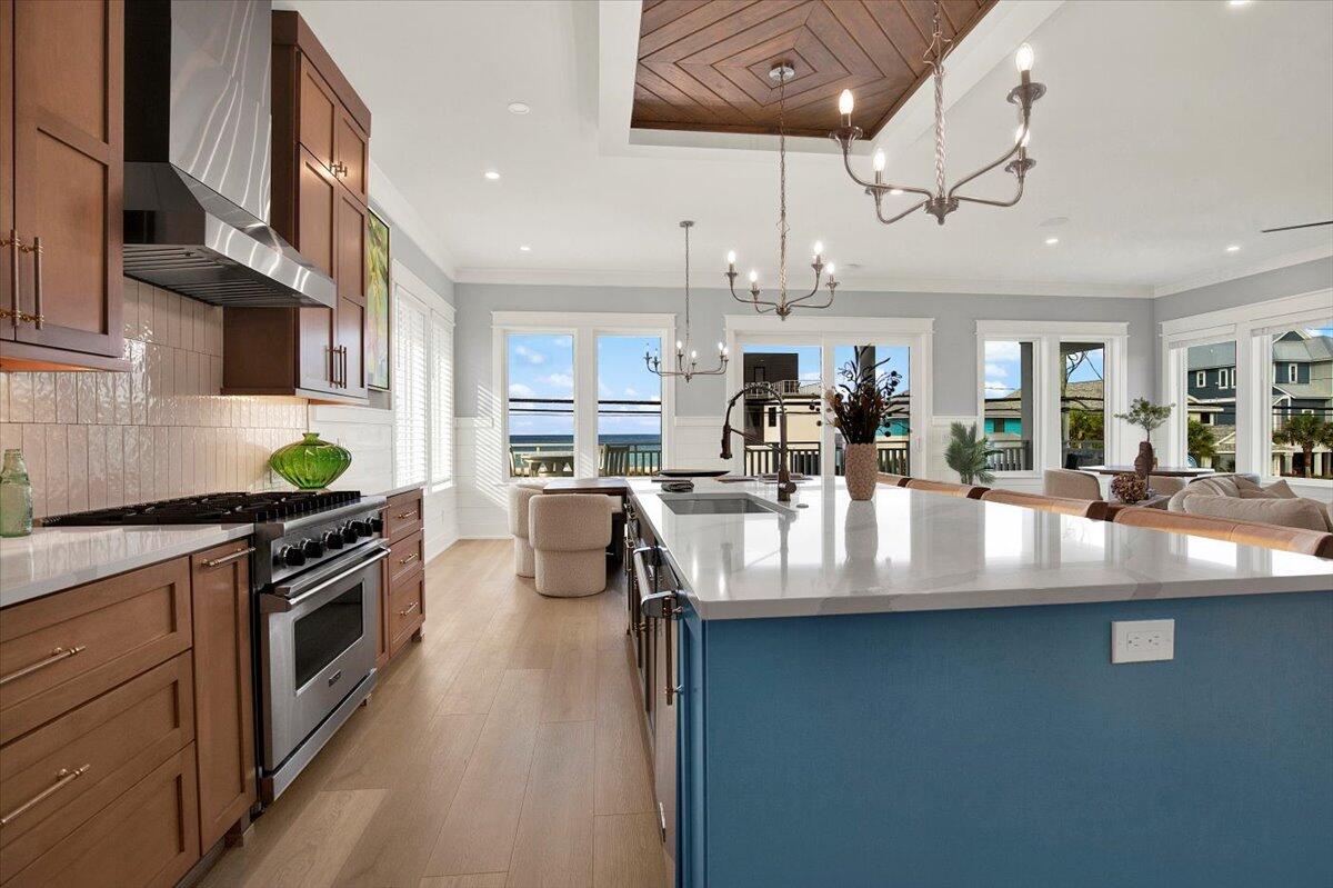 16418 Front Beach Road Panama City Beach, FL 32413 - Photo 22 of 40 a kitchen with stainless steel appliances granite countertop a sink a stove top oven a counter space and cabinets