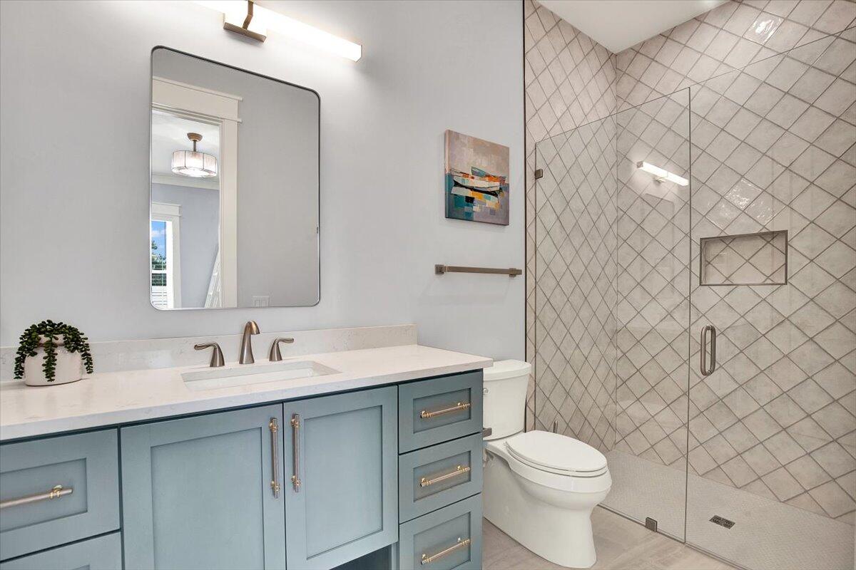 16418 Front Beach Road Panama City Beach, FL 32413 - Photo 9 of 40 a bathroom with a toilet sink and mirror