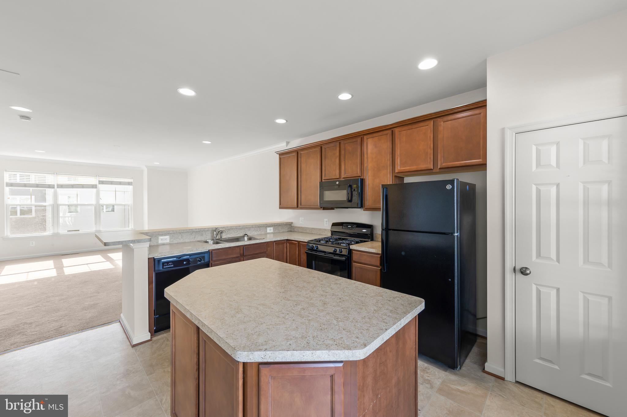 107 Fading Star Court Stephenson, VA 22656 - Photo 27 of 50 a kitchen with stainless steel appliances granite countertop a refrigerator a stove and a sink with wooden floor