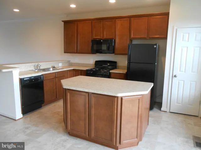 a kitchen with a sink a stove and refrigerator