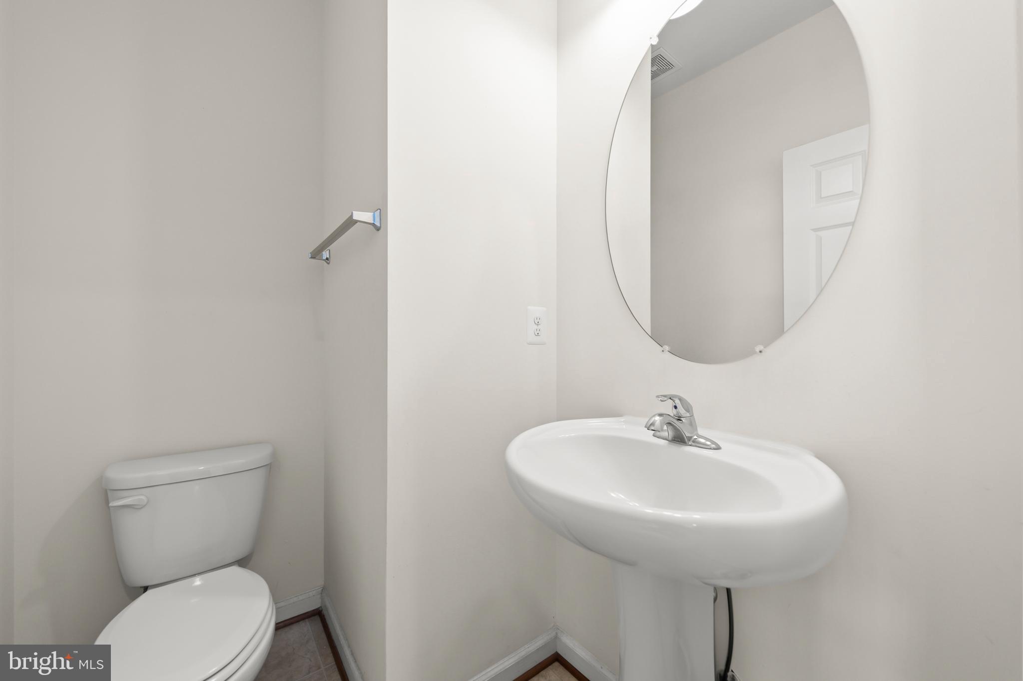 107 Fading Star Court Stephenson, VA 22656 - Photo 31 of 50 a bathroom with a toilet a sink and a mirror