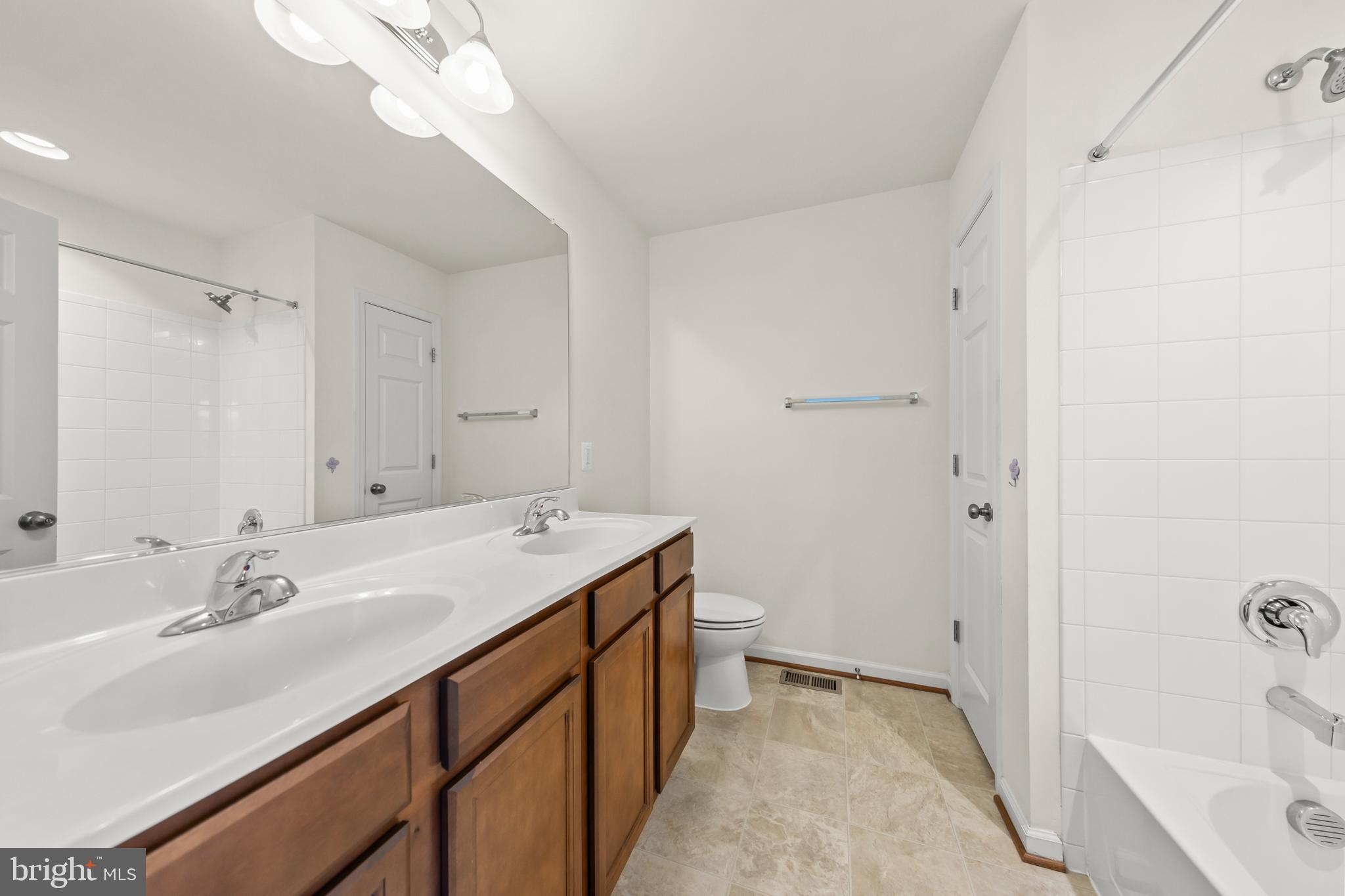107 Fading Star Court Stephenson, VA 22656 - Photo 35 of 50 a bathroom with a sink a mirror and a bathtub