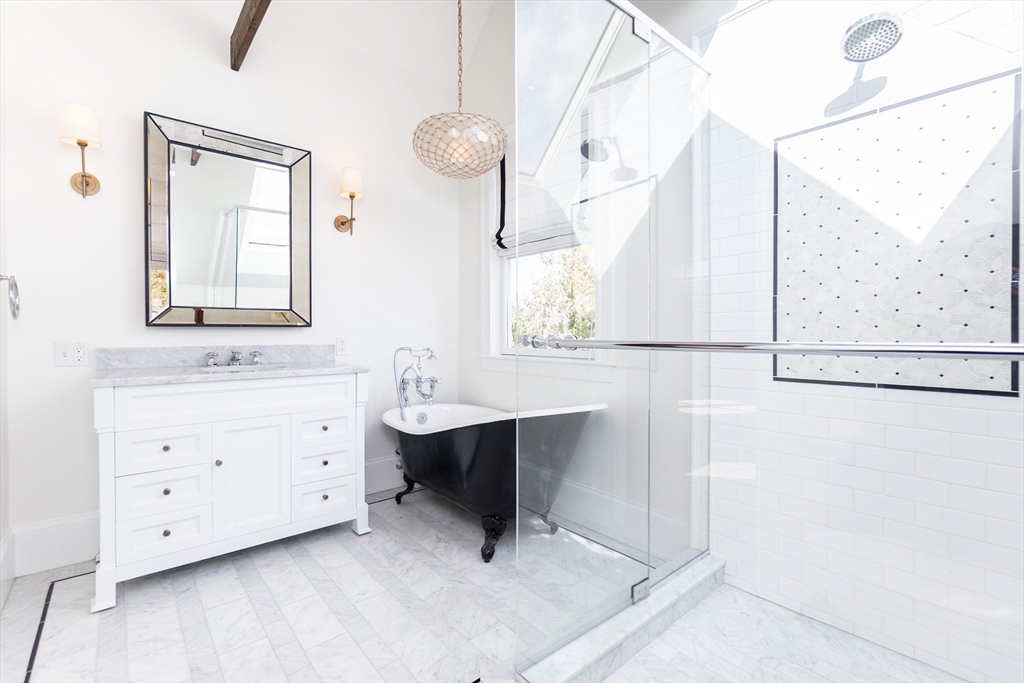 55 Phillips Street, Unit 55 Watertown, MA 02472 - Photo 7 of 15 a bathroom with a sink and a mirror