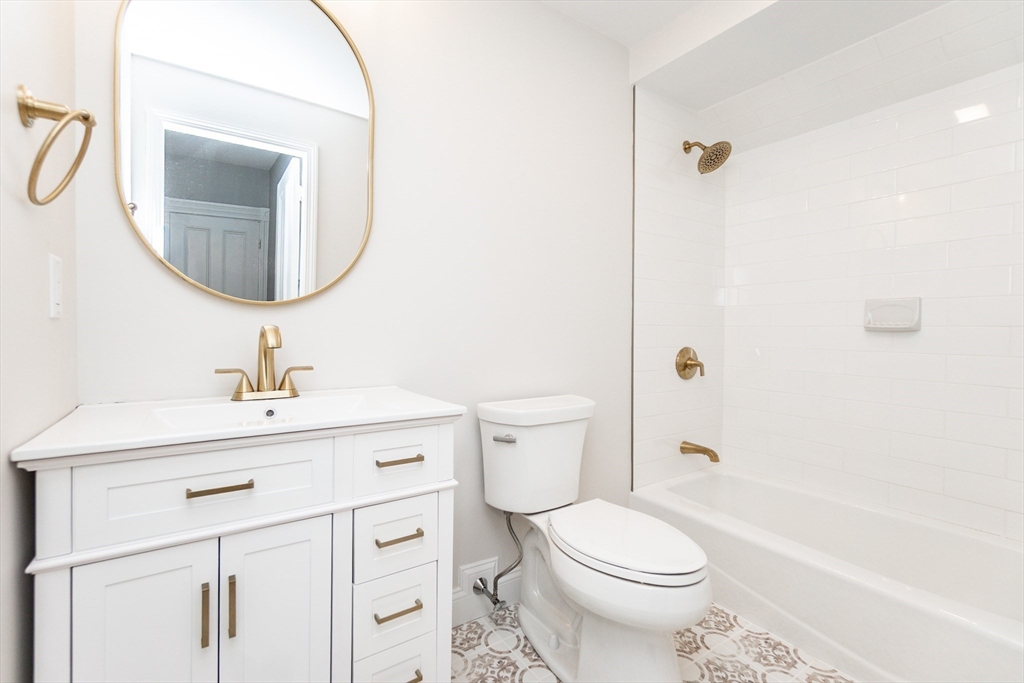 55 Phillips Street, Unit 55 Watertown, MA 02472 - Photo 10 of 15 a bathroom with a sink a toilet and a mirror