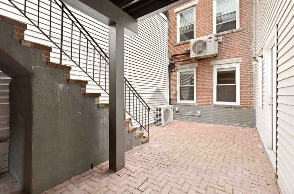 353 Sumner Street, Unit 1 Boston, MA 02128 - Photo 11 of 23 a view of a house with a backyard