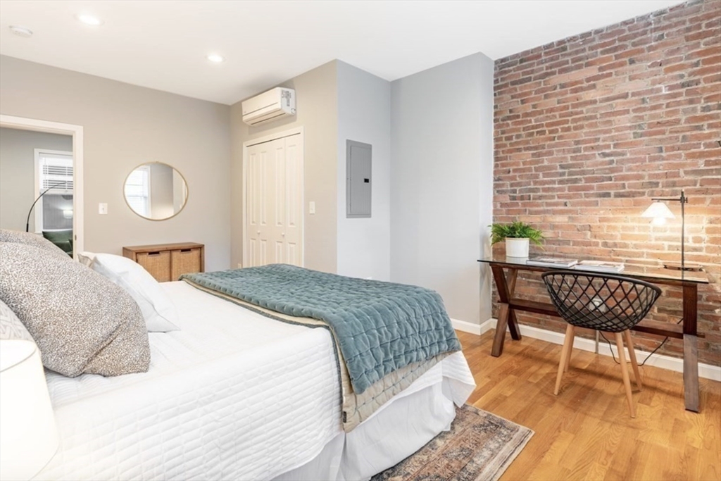353 Sumner Street, Unit 1 Boston, MA 02128 - Photo 13 of 23 a bedroom with a bed a chair and next to a window