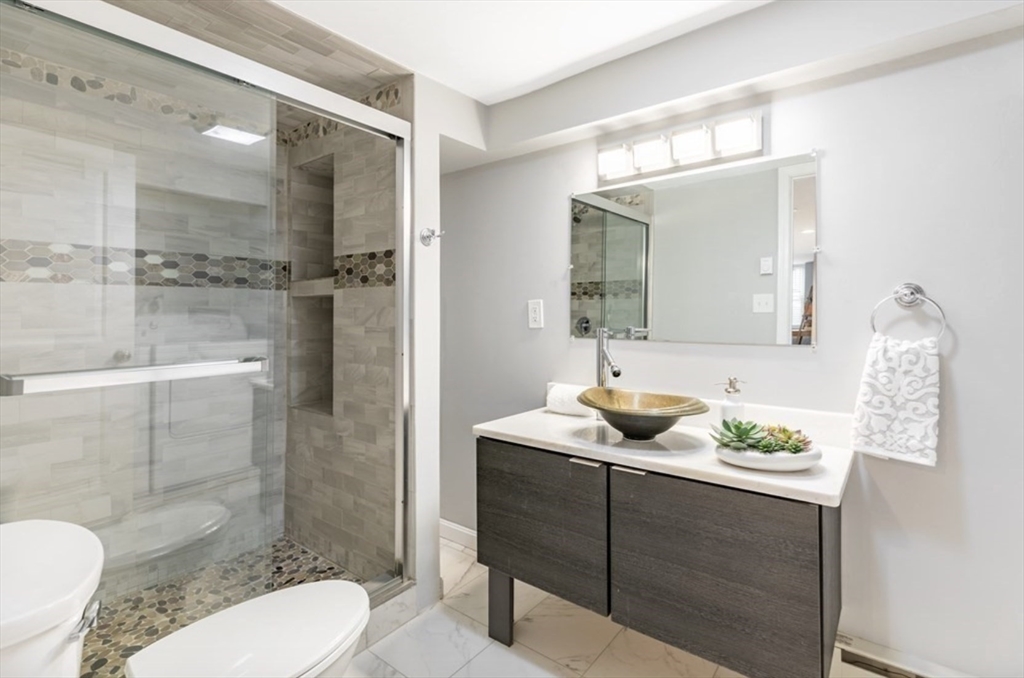 353 Sumner Street, Unit 1 Boston, MA 02128 - Photo 15 of 23 a bathroom with a sink a toilet and shower