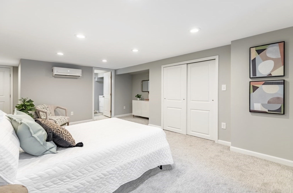 353 Sumner Street, Unit 1 Boston, MA 02128 - Photo 18 of 23 a spacious bedroom with a bed and painting on the wall