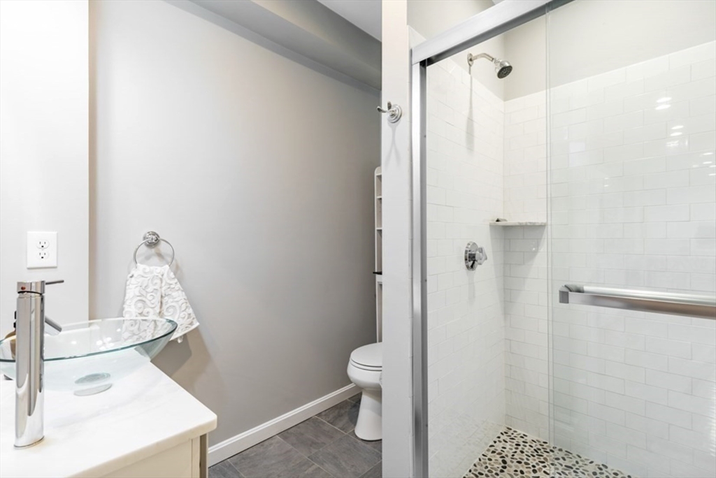 353 Sumner Street, Unit 1 Boston, MA 02128 - Photo 20 of 23 a bathroom with a sink a toilet and shower