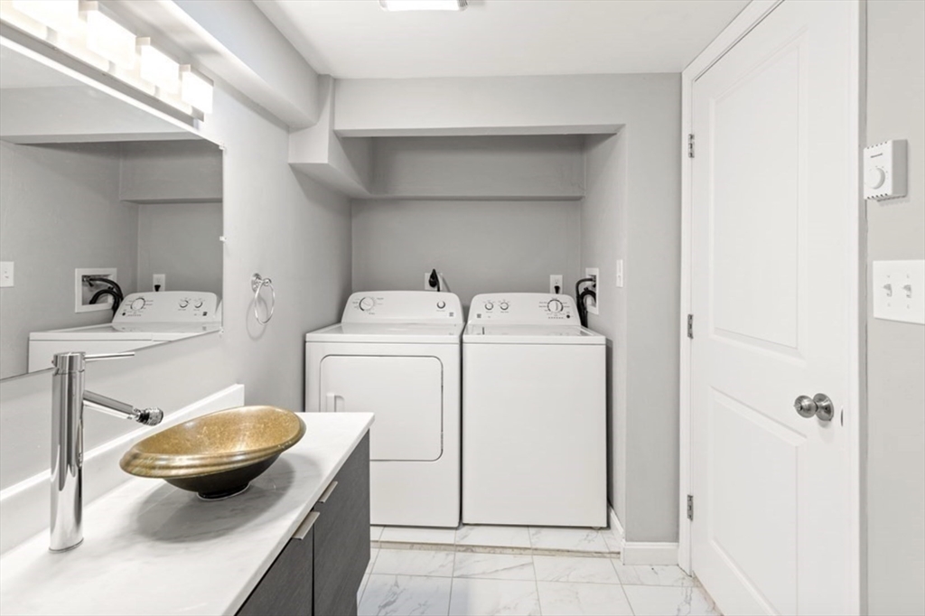 353 Sumner Street, Unit 1 Boston, MA 02128 - Photo 21 of 23 a bathroom with a toilet a sink and a mirror