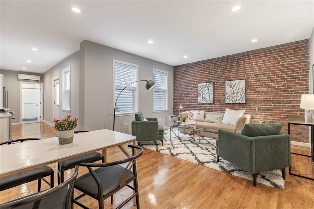 353 Sumner Street, Unit 1 Boston, MA 02128 - Photo 3 of 23 a living room with furniture and a wooden floor