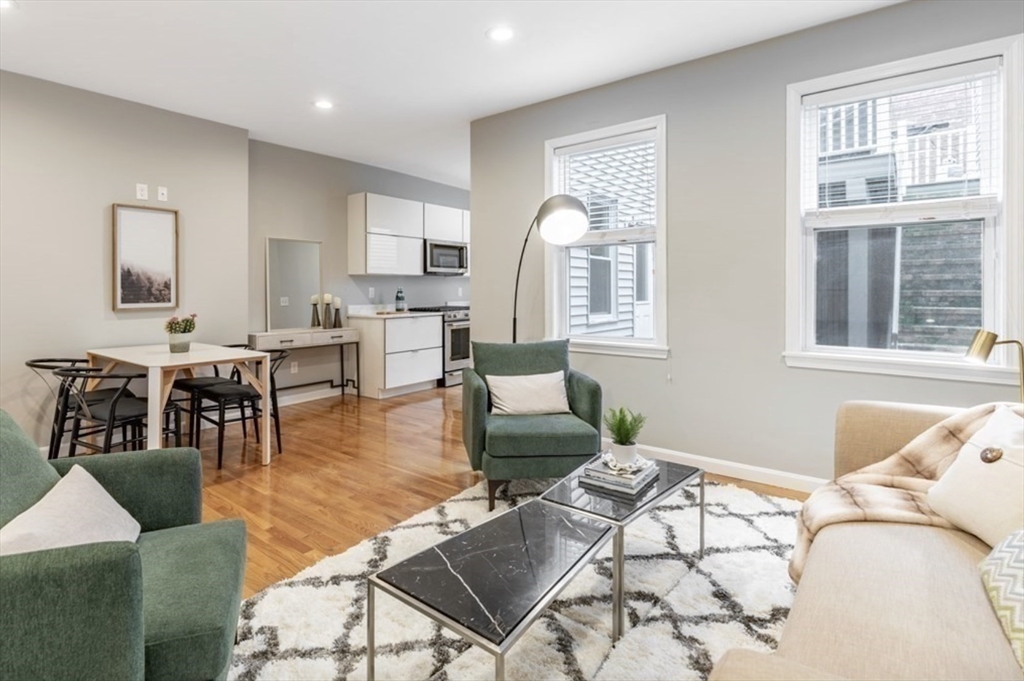 353 Sumner Street, Unit 1 Boston, MA 02128 - Photo 7 of 23 a living room with fireplace furniture and a large window