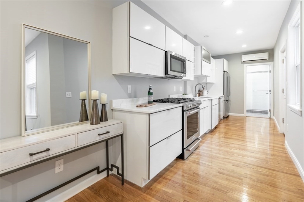353 Sumner Street, Unit 1 Boston, MA 02128 - Photo 9 of 23 a kitchen with a sink stove and cabinets